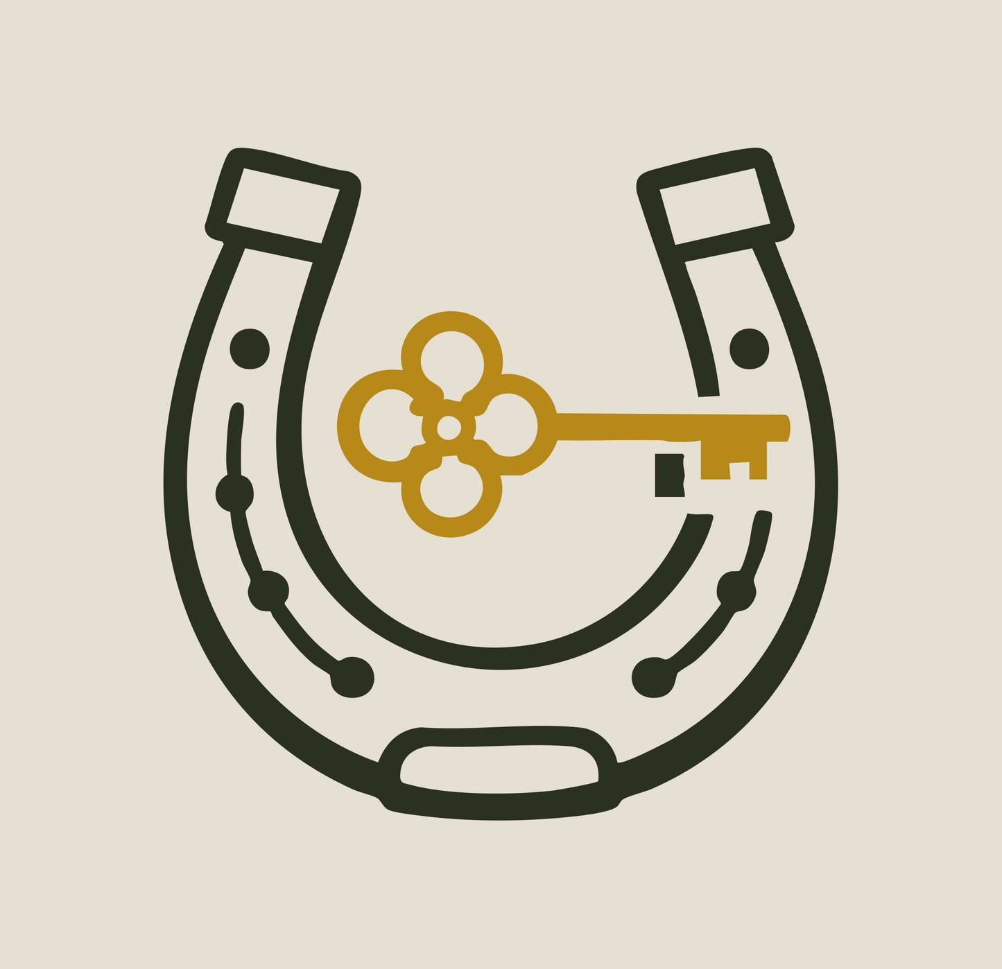 Horseshoe with a gold key symbol on a beige background